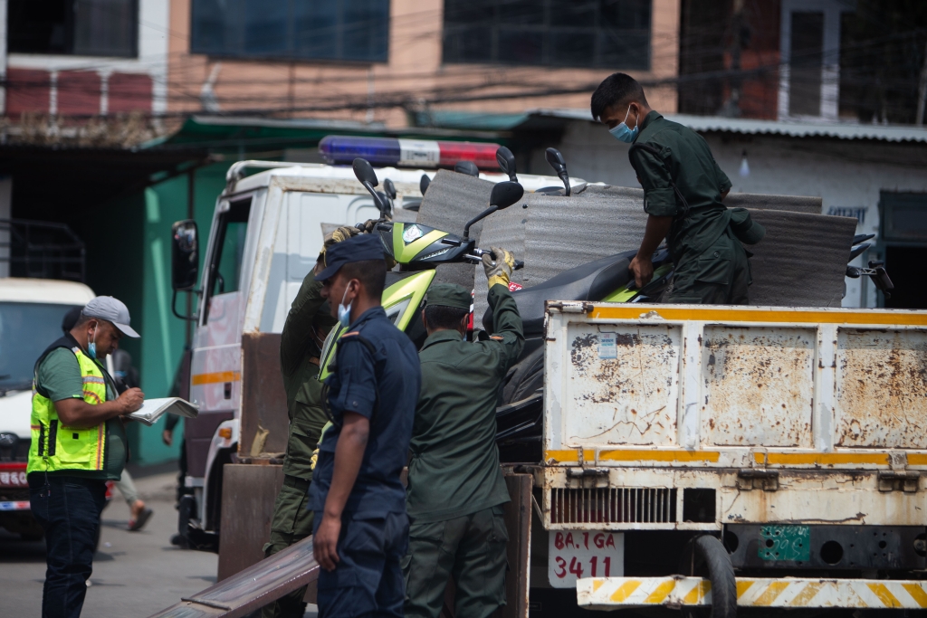 City police officers load illegally parked vehicles into their truck. (Image: Nishant Singh Gurung)