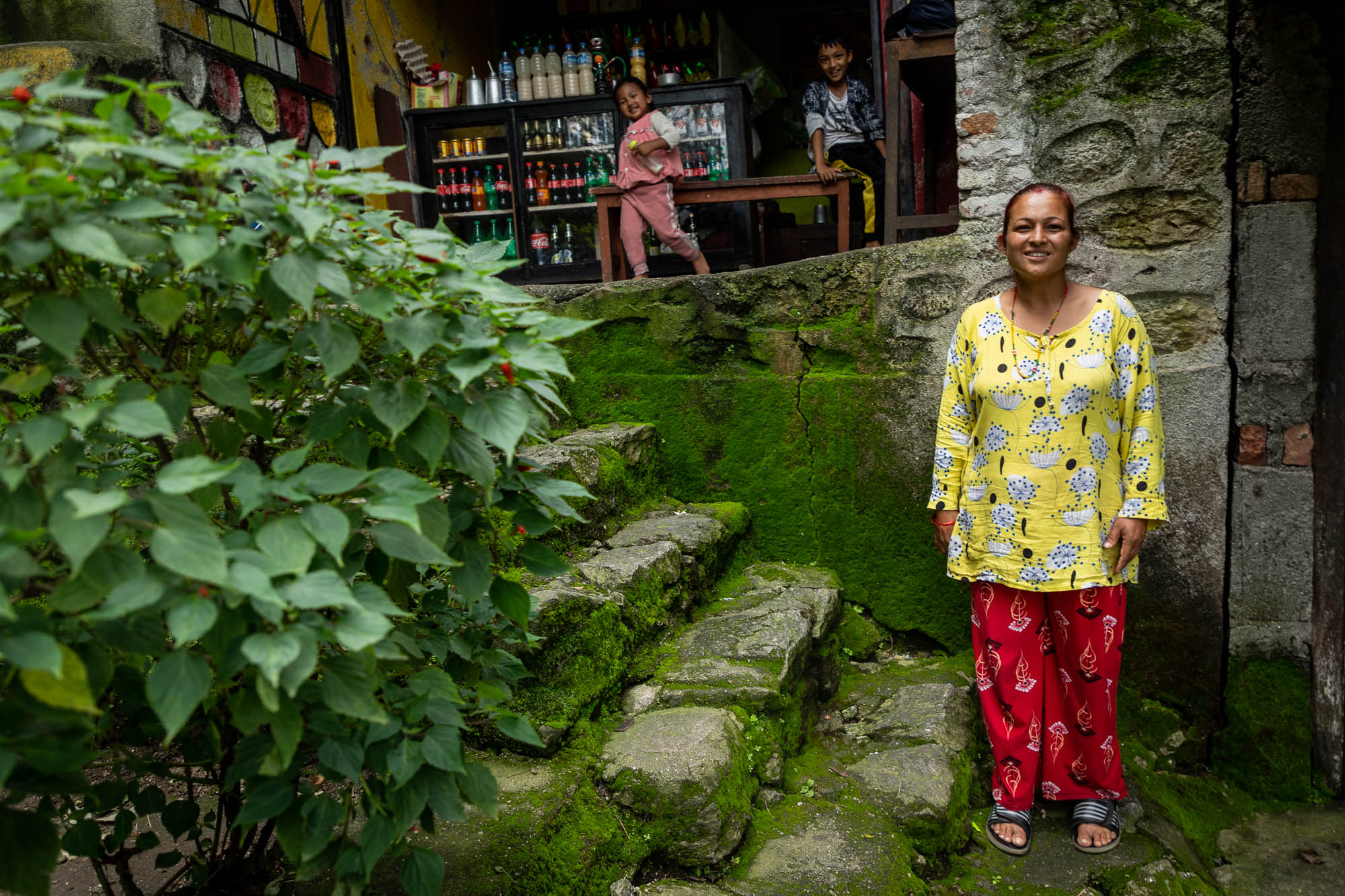 Sabina Shrestha stands in front of a shop in Gokarneshwar Municipality. Her family relies on the Bagmati for drinking water and other household use. They are one of the few households that have decided to manage liquid waste without dumping it into the river.
