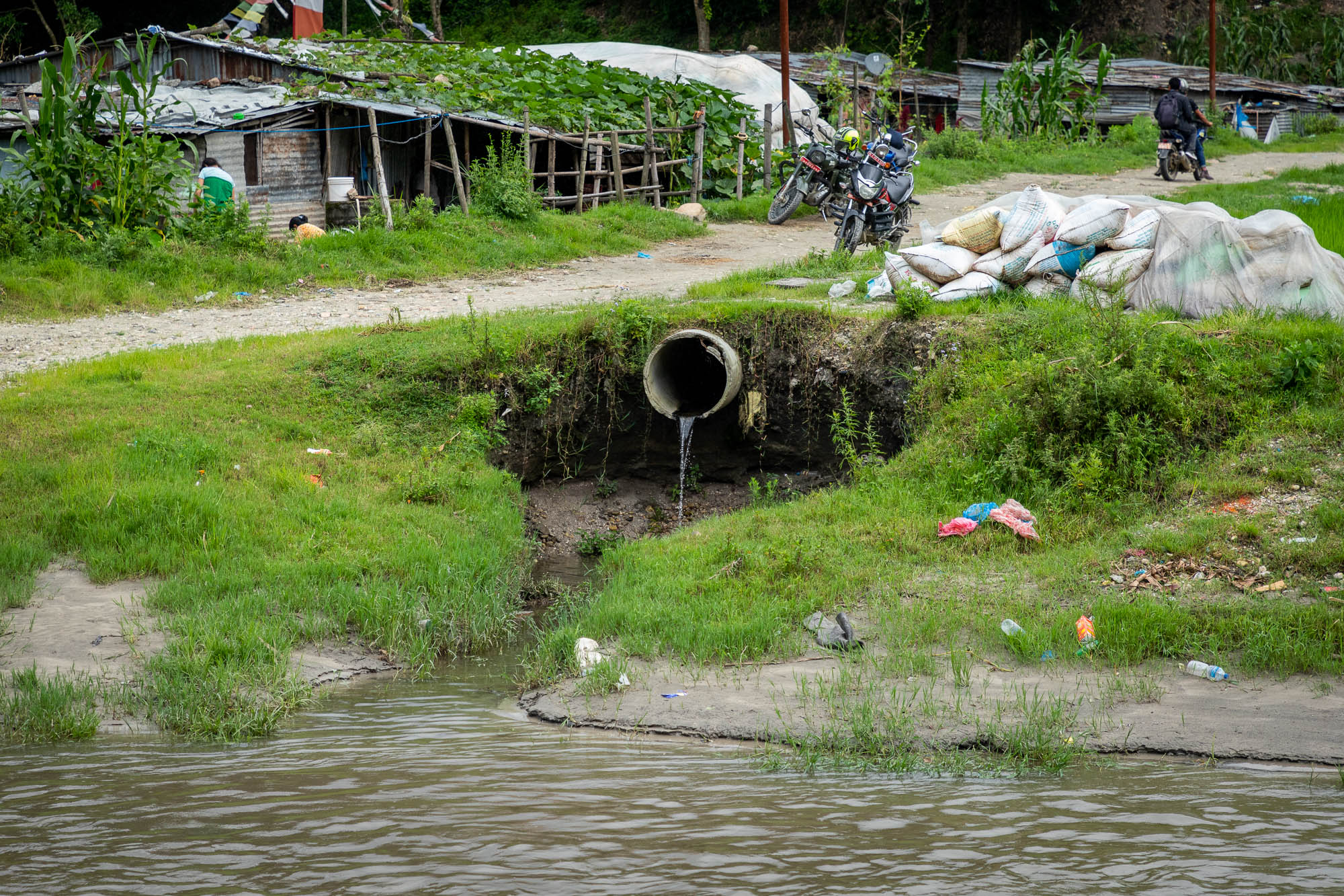 Wastewater flows from an open sewer pipe into the Bagmati River in Gokarneshwar Municipality.